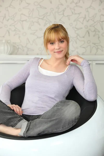 Woman sitting in armchair — Stock Photo, Image