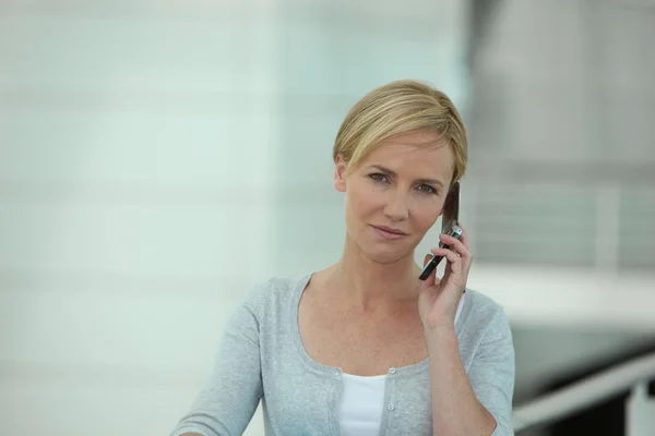 Young blond woman on the phone — Stock Photo, Image