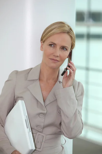 Executive with computer and phone — Stock Photo, Image