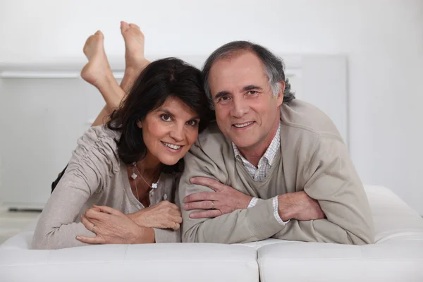 Mature couple lying in bed — Stock Photo, Image