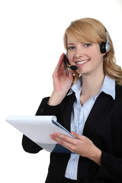 Woman with a telephone headset Stock Picture