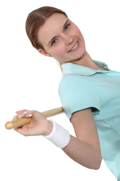 Woman exercising with a wooden pole Stock Photo