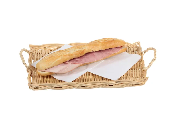 Simple ham baguette on a wicker tray — Stock Photo, Image