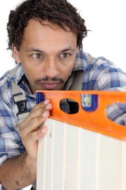 Carpenter using a spirit level clipart