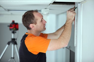 Man repairing office ceiling panel clipart