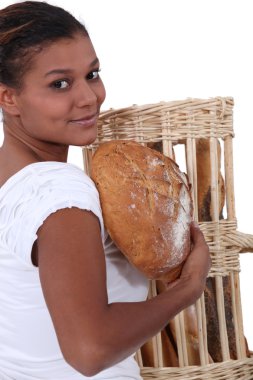 Young black woman holding bread in her arms clipart