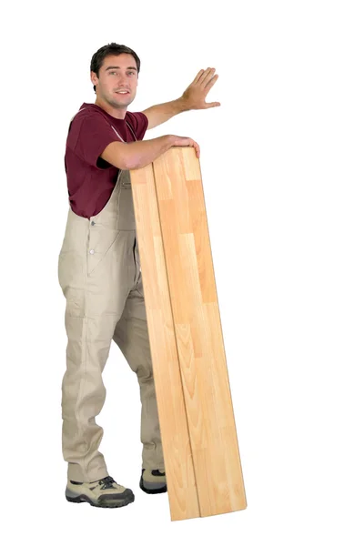 Worker holding planks of wood — Stock Photo, Image