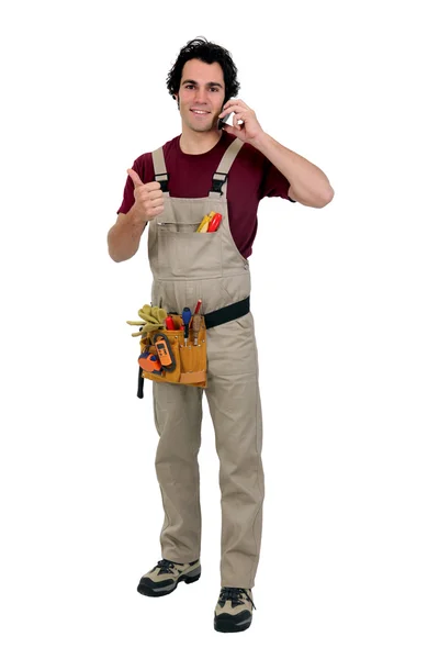 Craftsman talking on his say and doing the thumbs up sign — Stock Photo, Image