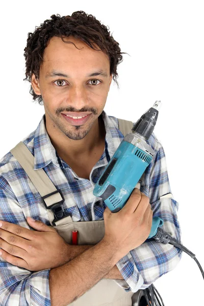 Tradesman segurando uma chave de fenda elétrica — Fotografia de Stock