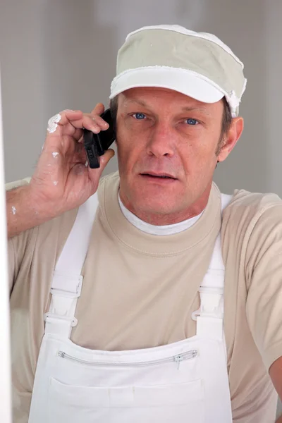 Painter accepting call from customer — Stock Photo, Image