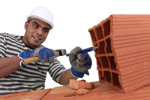 Bricklayer at work with red bricks indoors — Stock Photo, Image