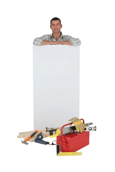 Carpenter with a blank board — Stock Photo, Image