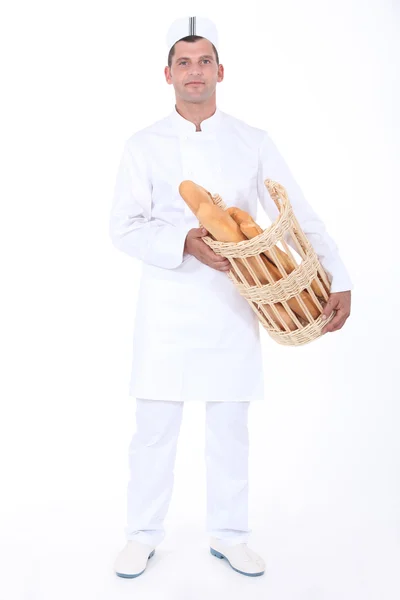 Padeiro com cesta de pão — Fotografia de Stock