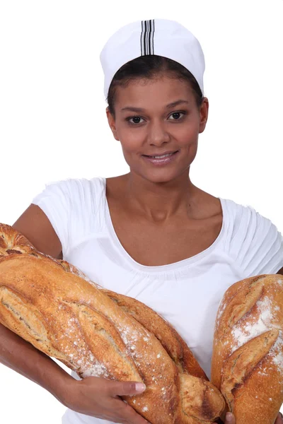 Female baker with large loaves of bread — Stock Photo, Image