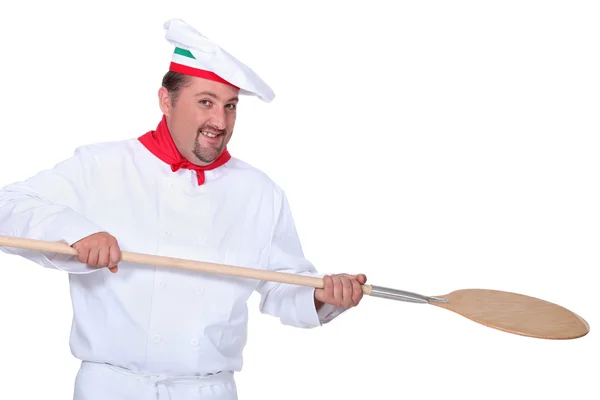 Pizza chef holding a pizza loading peal — Stock Photo, Image