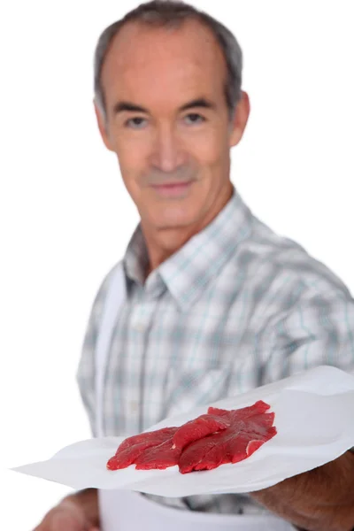 Butcher showing steak — Stock Photo, Image