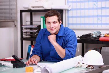 Construction foreman working in the office clipart