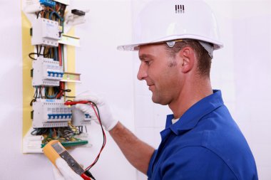 Electrician measuring voltage clipart