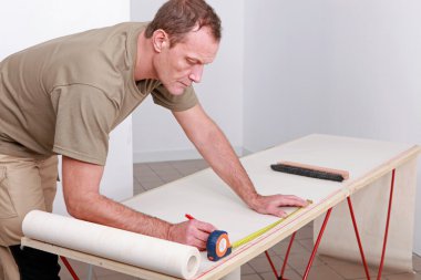 Man measuring wallpaper clipart