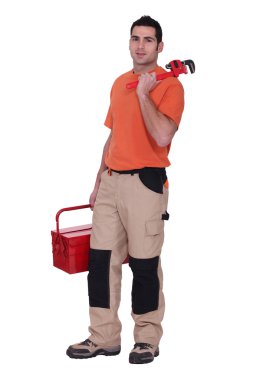 Handyman stood with wrench and tool kit clipart