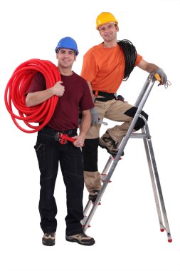 Two electricians working together clipart
