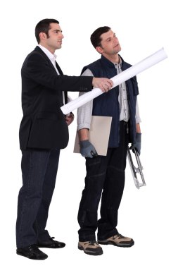 Businessman giving explanations to a craftsman clipart