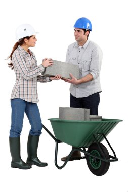 Male and female bricklayers working together clipart
