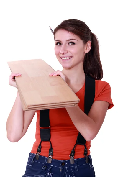 Handywoman holding wooden boards — Stock Photo, Image