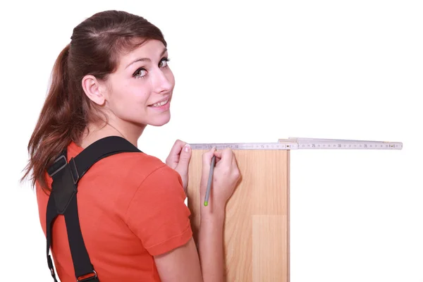 Female woodworker measuring a board — Stock Photo, Image