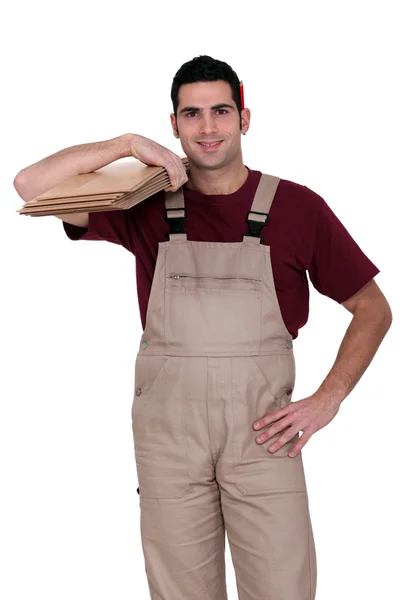 Man ready to fit laminate flooring — Stock Photo, Image