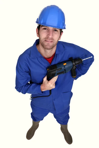 Stavební dělník, který drží vrtačku. — Stock fotografie