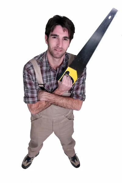 Craftsman holding a saw — Stock Photo, Image