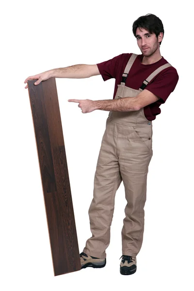 Woodworker standing with laminate flooring — Stock Photo, Image