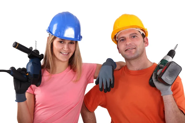 Hantverkare och hantverkerska hålla borrar — Stockfoto