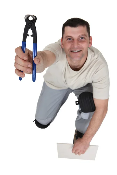Happy tiler showing nippers — Stock Photo, Image