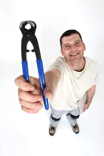 A man presenting pliers. — Stock Photo, Image
