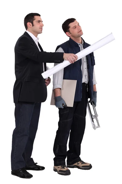 Businessman giving explanations to a craftsman — Stock Photo, Image