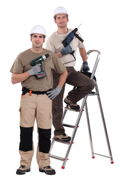 Two craftsmen holding drills — Stock Photo, Image