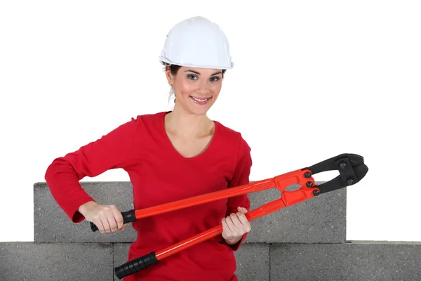Woman holding large pliers — Stock Photo, Image