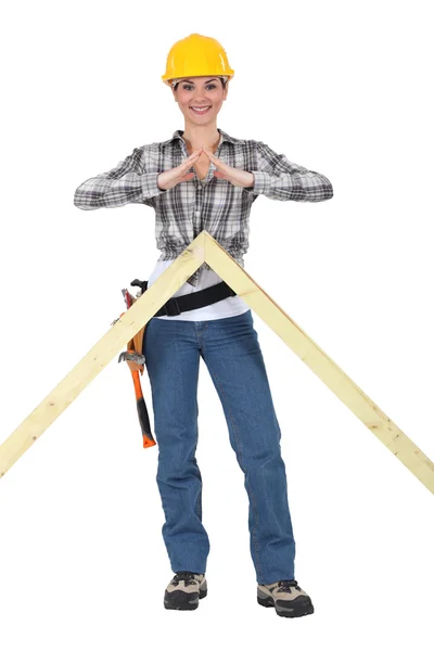 Woman with the apex frame of a house — Stock Photo, Image