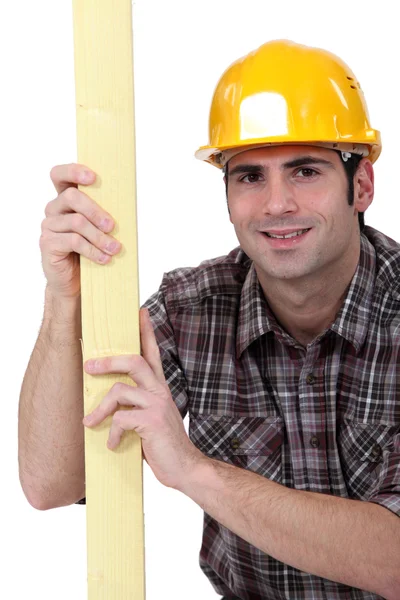 Mason stood with plank of wood — Stock Photo, Image