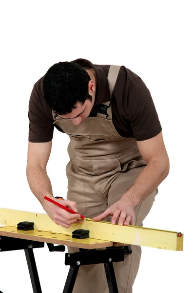 Man measuring wooden plank — Stock Photo, Image