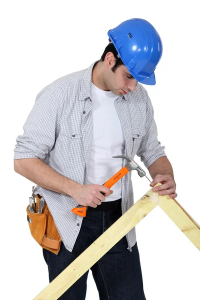 Portrait of joiner hammering down nail — Stock Photo, Image