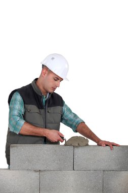 Man spreading mortar with a trowel clipart