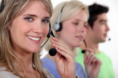 Woman and colleagues wearing headsets clipart