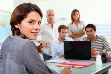 Students gathered around laptop in class clipart