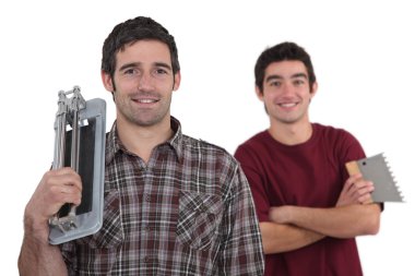 A team of tile fitters holding tools clipart