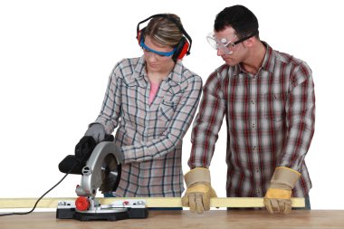 Apprentice with circular saw clipart