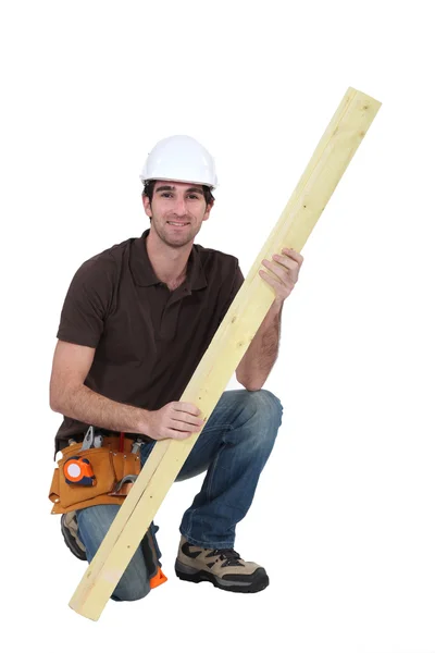 Carpintero con tablón de madera — Foto de Stock