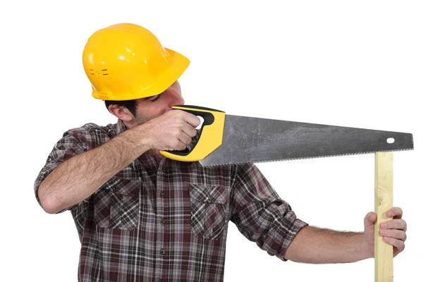A carpenter with a handsaw. — Stock Photo, Image